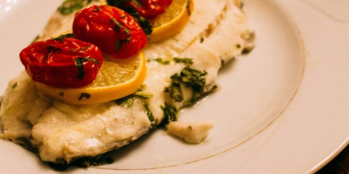 white and brown pastry with strawberry on top on white ceramic plate