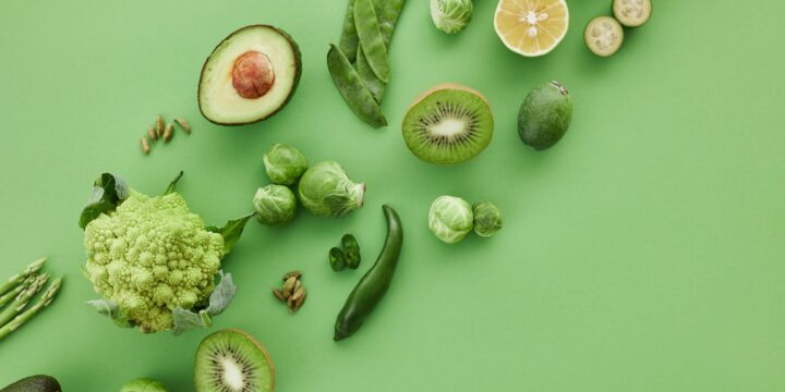 Slices of Fruits Beside Green Vegetables