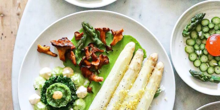 White asparagus with sauce near vegetarian dishes with herbs