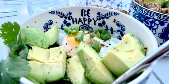 sliced green fruit on white and blue ceramic bowl