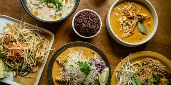 a wooden table topped with plates of food